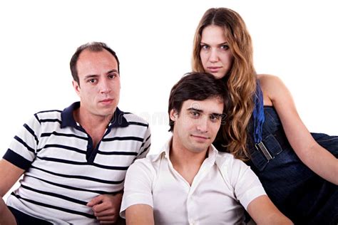 Two Men And A Woman Sitting On The Couch Stock Photo Image