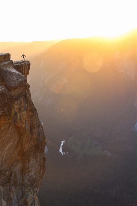 Silhouette Of Person Standing On Cliff During Sunset Hd Phone