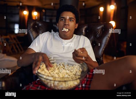 Guy With Bowl Of Popcorn Watching Movie Stock Photo Alamy