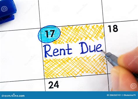 Woman Fingers With Pen Writing Reminder Rent Due In Calendar Stock