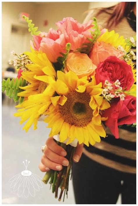 A Woman Holding A Bouquet Of Sunflowers And Roses