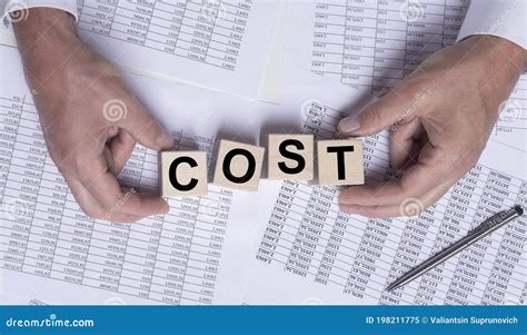 Cost Word On Wooden Cube Blocks On Financial Documents Top View Stock