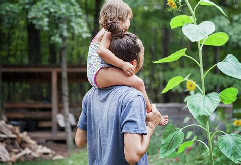 Happy Father Carrying Girl On Shoulders In Backyard Photograph By Cavan