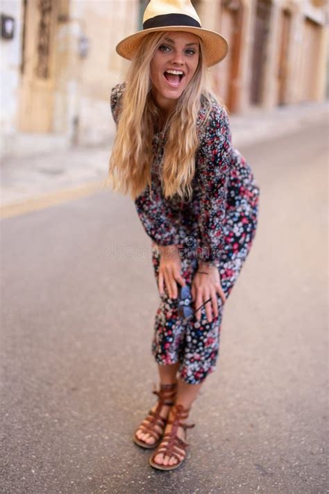 Blonde Mediterranean Woman Floral Pattern Dress Posing Concept Stock
