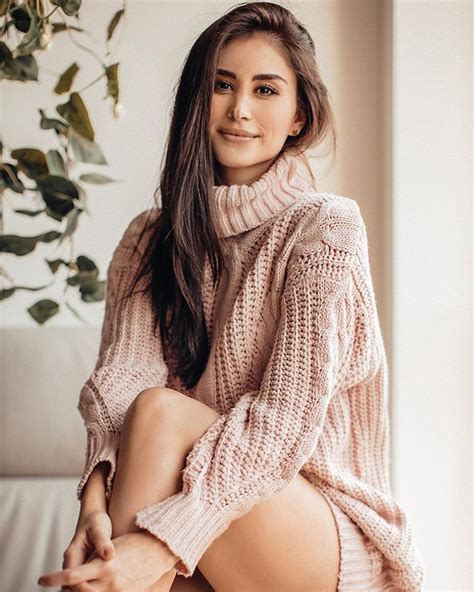 A Woman Sitting On Top Of A White Couch