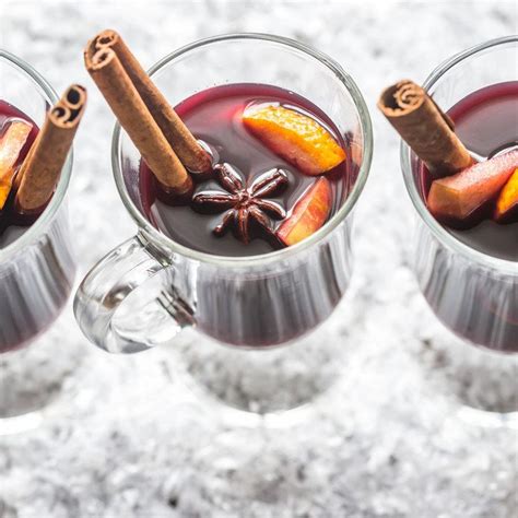 Three Mugs Filled With Hot Chocolate And Cinnamon