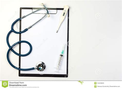 Stethoscope Syringe And Thermometer On Clipboard With Blank Paper