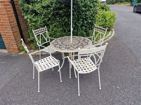 Heavy Metal And Mosaic Garden Table And Four Stackable Chairs In Crystal