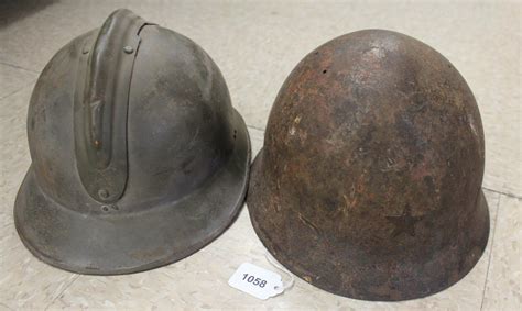 Lot - TWO MILITARY HELMETS