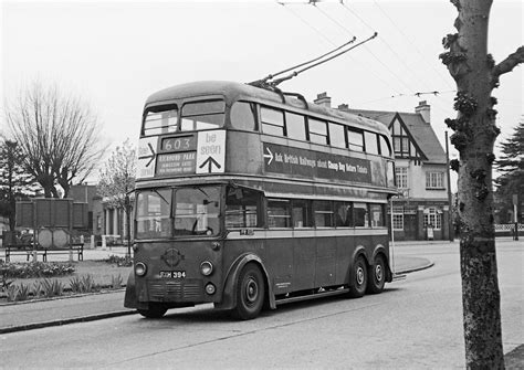 An Old Double Decker Bus Driving Down The Street