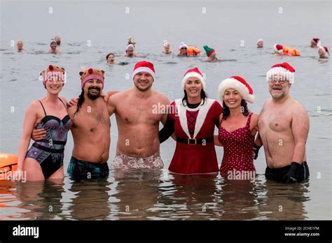 Team Dash And Splash Swimmers In Christmas Hats Pose As They Stand In