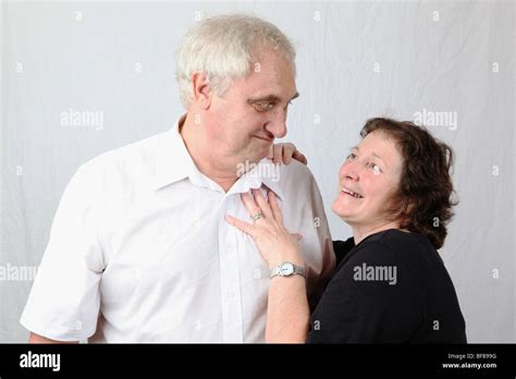 Older Mature Married Couple Husband And Wife Getting Amorous With Each Other Smiling Teasing