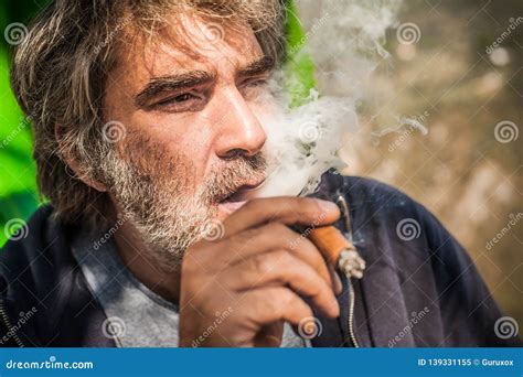 Portrait Of Bearded Caucasian Man Smoking A Cigar Stock Image Image