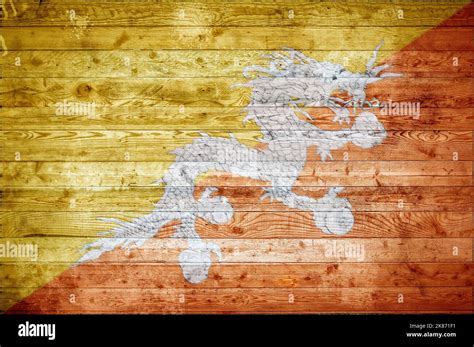 A Vignetted Background Image Of The Flag Of Bhutan Painted Onto Wooden