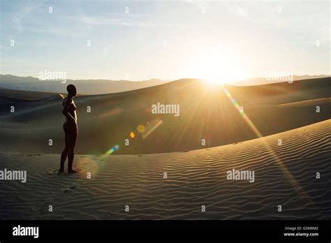 Nude Woman In Desert On Sand Dune Looking Away Stock Photo Alamy