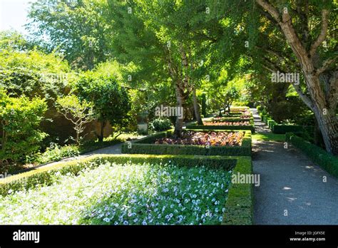 Formal Garden With Flowers Set Among Hedges Designed To Keep Out
