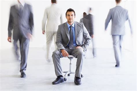 Portrait Chair And A Business Man In A Busy Office With Motion Blur