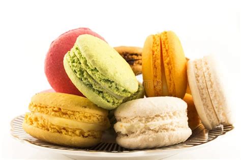 A Pile Of Colorful Macaroons On A Plate Isolated On White Background