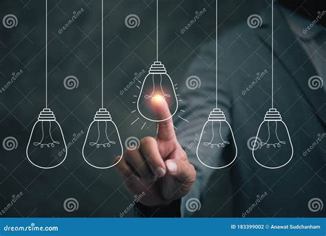 Businessman Pointing Light Bulb To Get A New Idea From Brain Storming