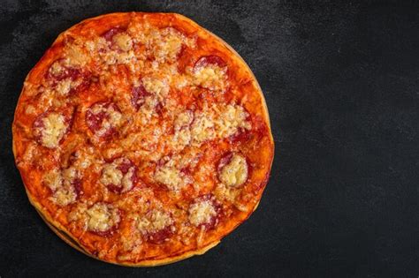 Premium Photo | Pizza salami sausages (tomato sauce, cheese, meat)