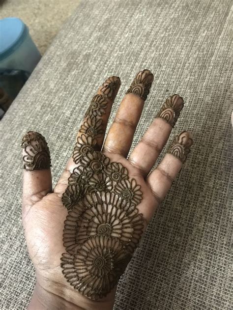 A Person S Hand With Henna Tattoos On It