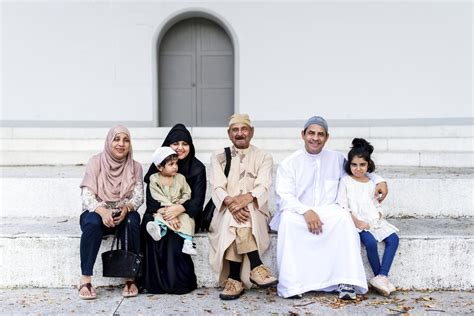 Muslim family sitting together outdoors | Photo - rawpixel