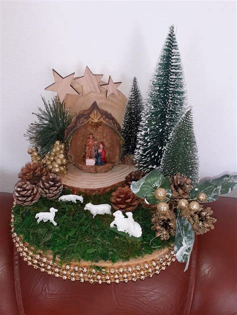 A Nativity Scene Is Displayed On Top Of A Red Leather Couch With Pine