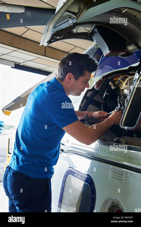 Male Aero Engineer Working On Helicopter In Hangar Stock Photo Alamy