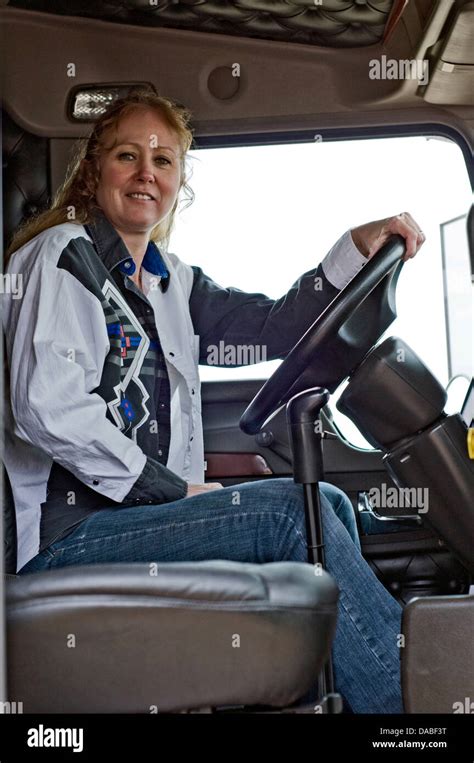 Woman Truck Driver Sitting In The Drivers Seat Of A Semi Truck Stock