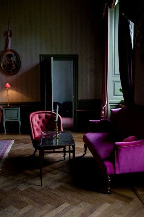 A Living Room Filled With Purple Furniture Next To A Window