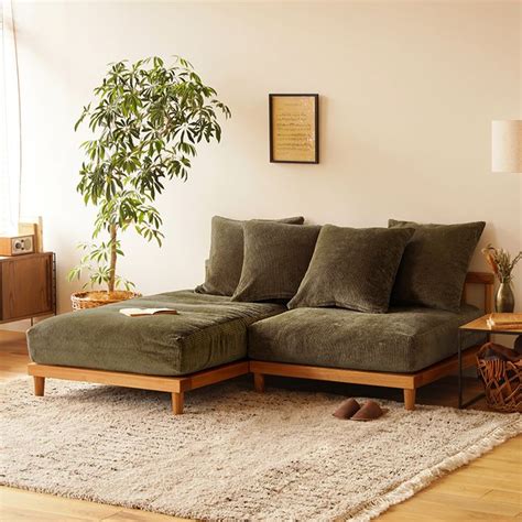 A Living Room Scene With Focus On The Couch And Pillows Rugs And A