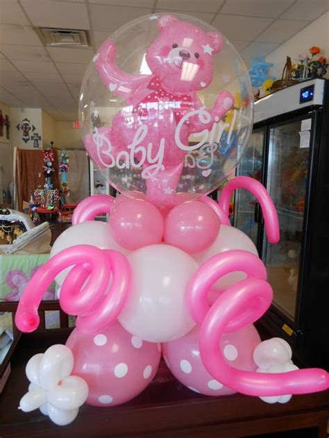 A Pink And White Balloon In The Shape Of A Teddy Bear Sitting On Top Of