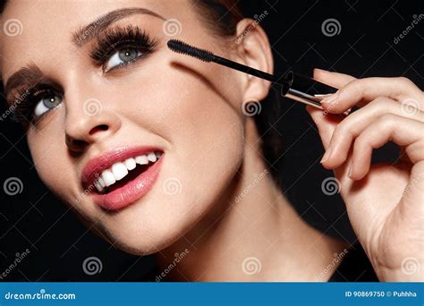 Cosmetics Beautiful Woman With Perfect Makeup Applying Mascara Stock