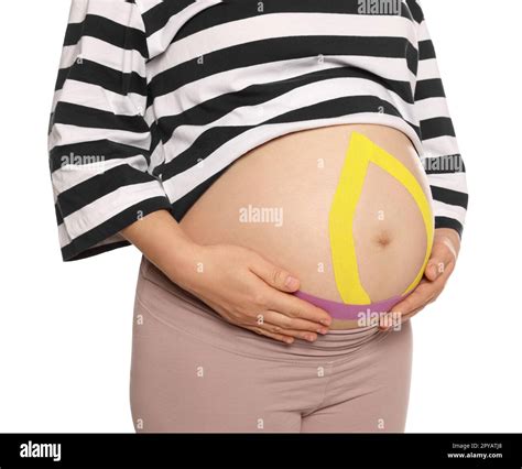 Pregnant Woman With Kinesio Tapes On Her Belly Against White Background