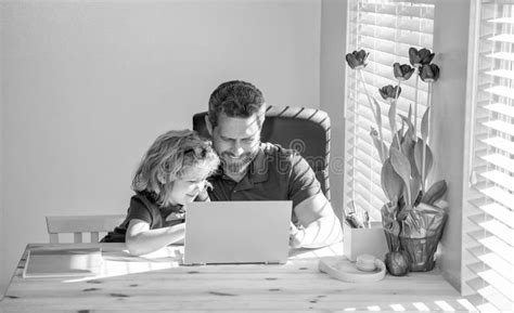 Happy Mature Man Teacher Or Dad Helping Kid Son With School Homework On Computer Education