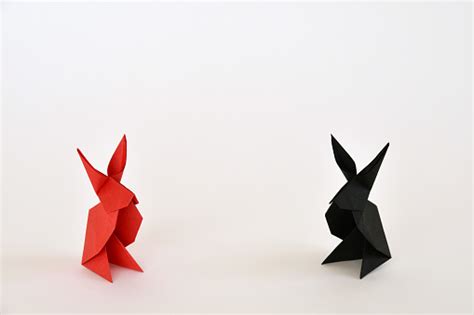 Red And Black Origami Paper Rabbits On White Background Stock Photo ...