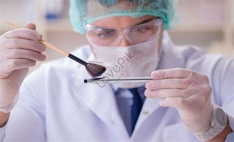 Forensic Investigator Working In Laboratory Examining Crime Evidence