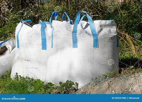 White Big Bulk Bags Full Of Potting Soil On The Grass Stock Photo