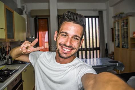 Handsome Caucasian Man Taking A Selfie Portrait Indoor At Home Happy