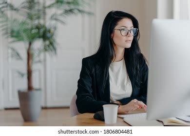 Horizontal Shot Concentrated Brunette Woman Sits Stock Photo 1806804487