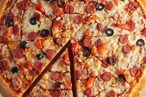 Premium Photo Pepperoni Pizza Adorned With Black Olives And Red Bell