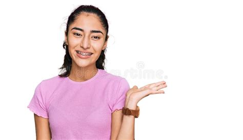 Hispanic Teenager Girl With Dental Braces Wearing Casual Clothes