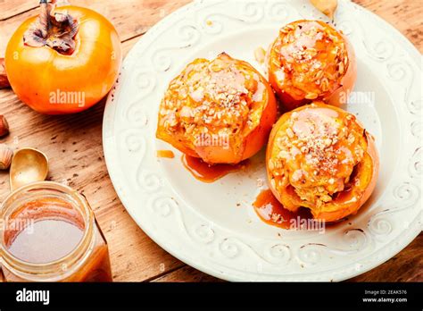 Baked Persimmon With Granola Stock Photo Alamy