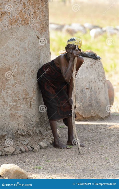 Unidentified Ghanaian Old Woman Leans On The Wall And Wooden St