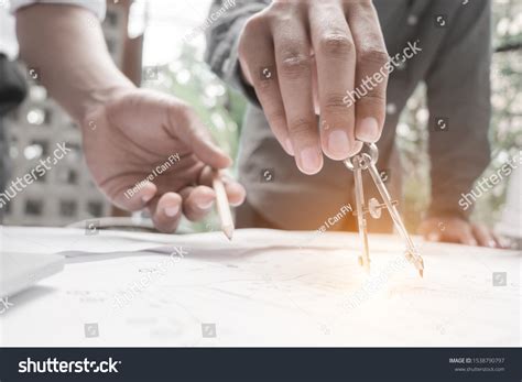 Engineers Pointing Building On Blueprint Drawing Stock Photo 1538790797