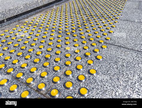 Gray Granite Staircase With Yellow Tactile Indicators For Visually