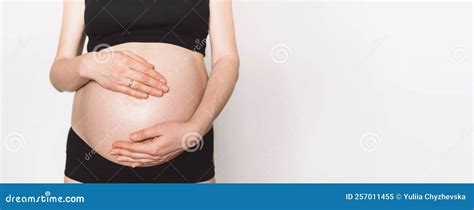 Pregnant Woman Expecting Baby In Comfortable Top And Leggings Holding Naked Pregnant Tummy