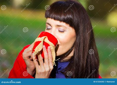 Happy Woman Drinking Hot Tea In Autumnal Park Autumn Stock Photo