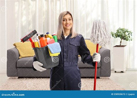 Professional Female Cleaner In A Uniform Holding A Bucket Of Cleaning