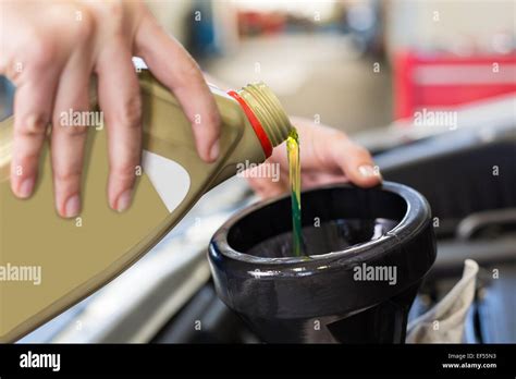 Mechanic Pouring Oil Into Car Stock Photo Alamy